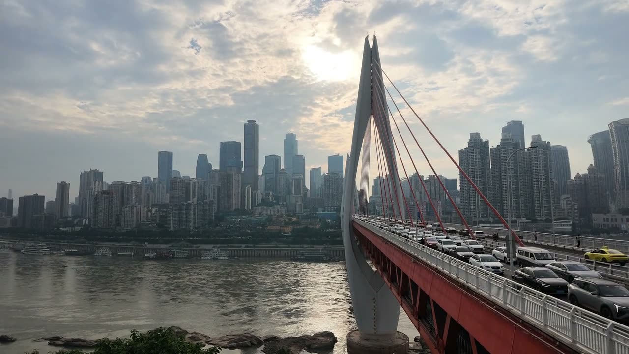 The peninsula skyline and the Dongshuimen bridge at dusk from the old street on the south bank.