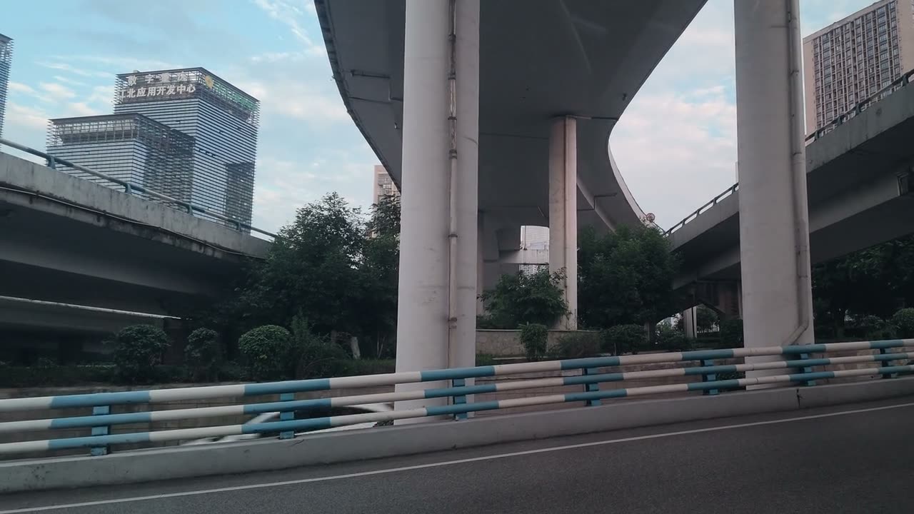 Stacked concrete ramps of an elevated interchange seen from the road beneath them.